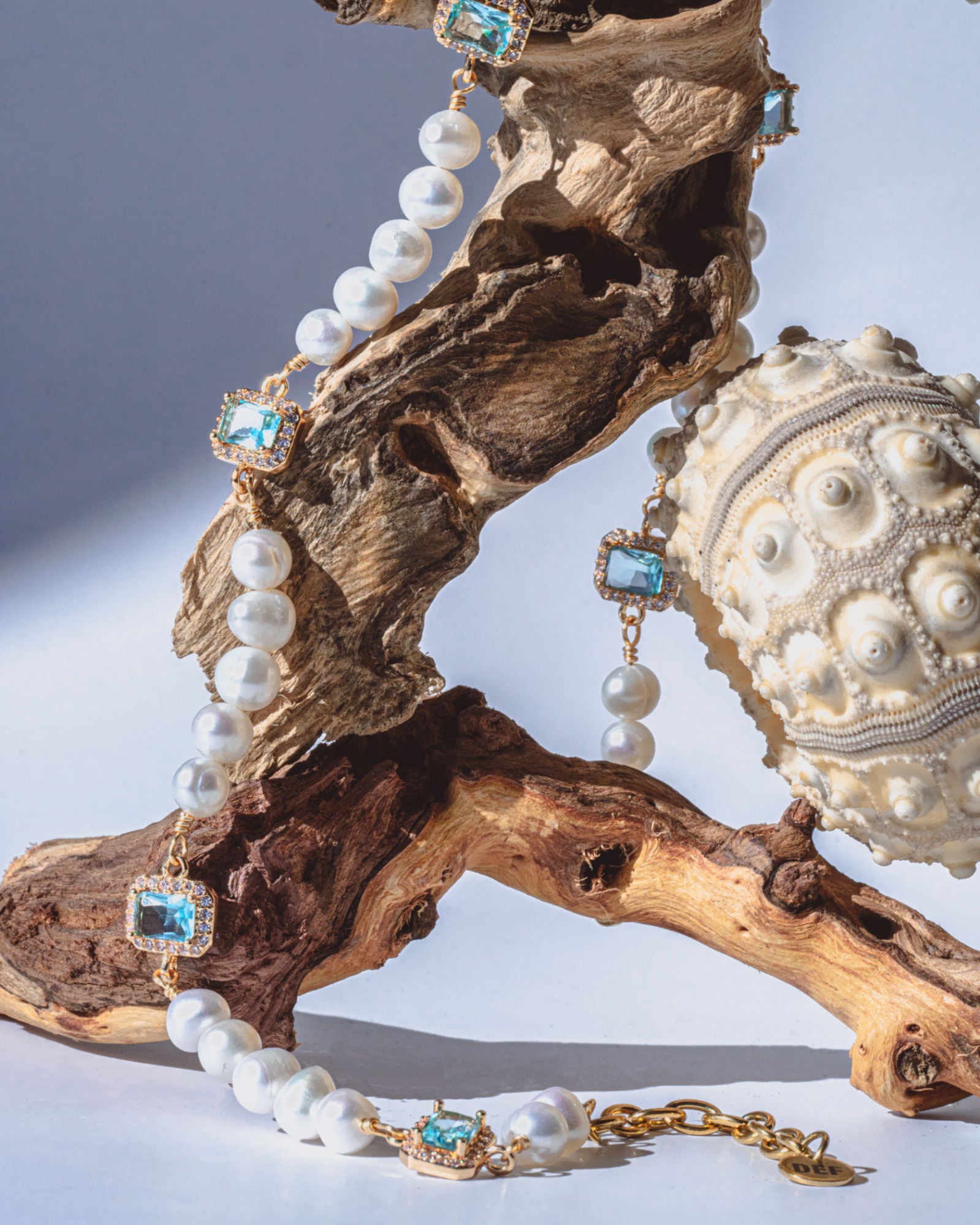 Editorial shoot of GEMS AND PEARLS SIGNATURE BRADED NECKLACE - Disco Eros Finos -Handmade jewelry pearls crystal gems rings and chains (blue)
