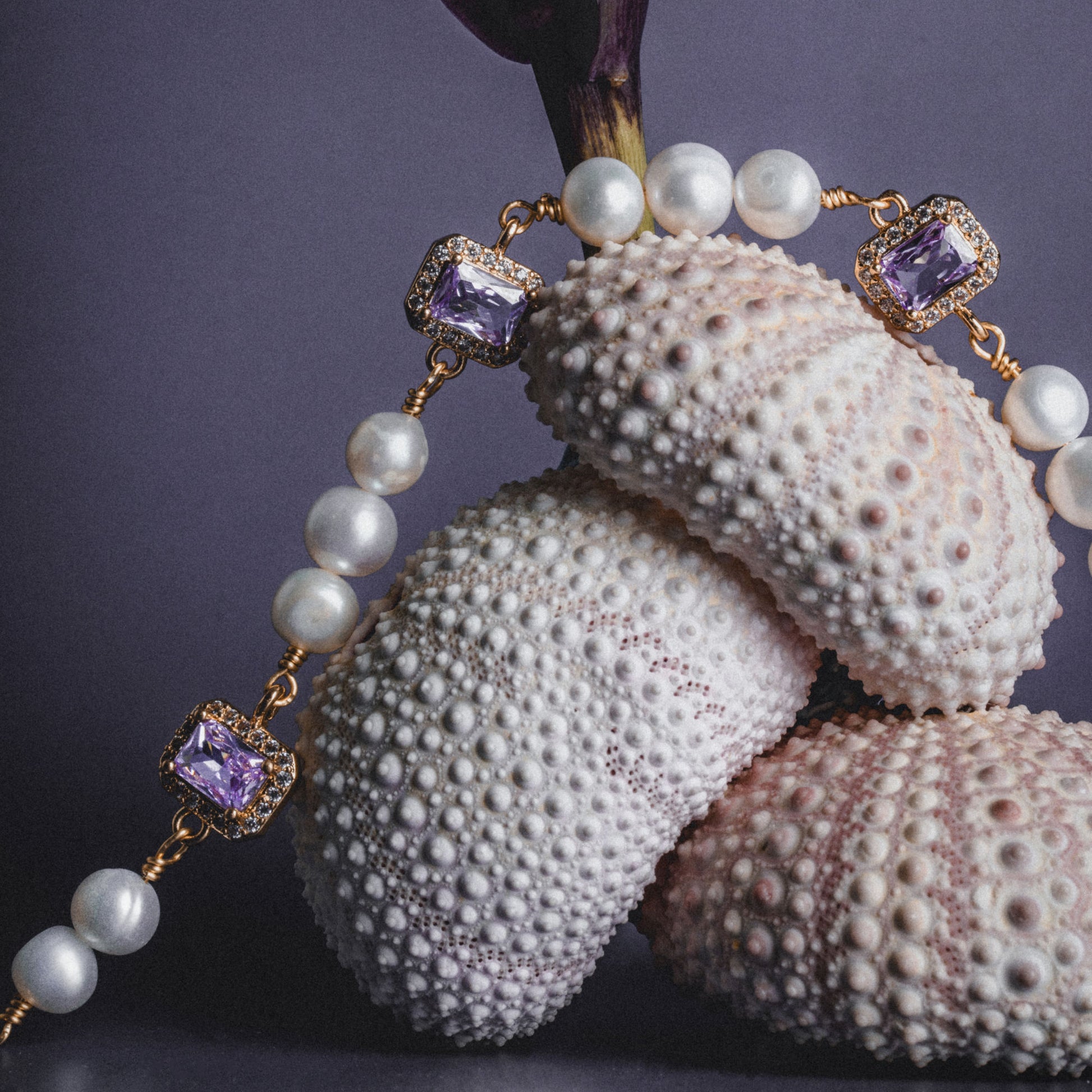 Editorial shoot of GEMS AND PEARLS SIGNATURE BRADED BRACELET - Disco Eros Finos -Handmade jewelry pearls crystal gems rings and chains (purple)