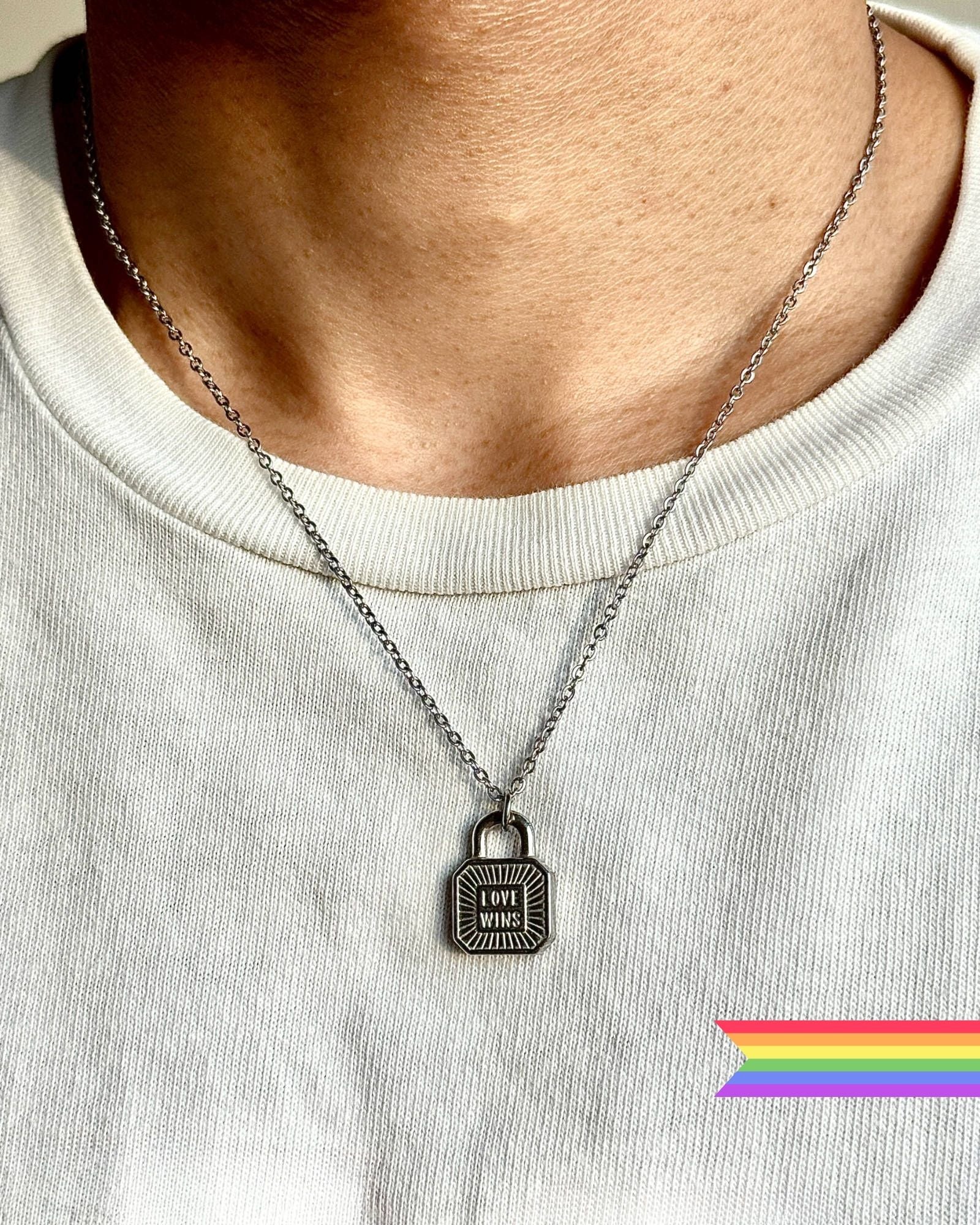Female model wearing love Wins Lock pendant Necklace - Pride month special, non-tarnish Stainless steel chain by DEF Jewelry